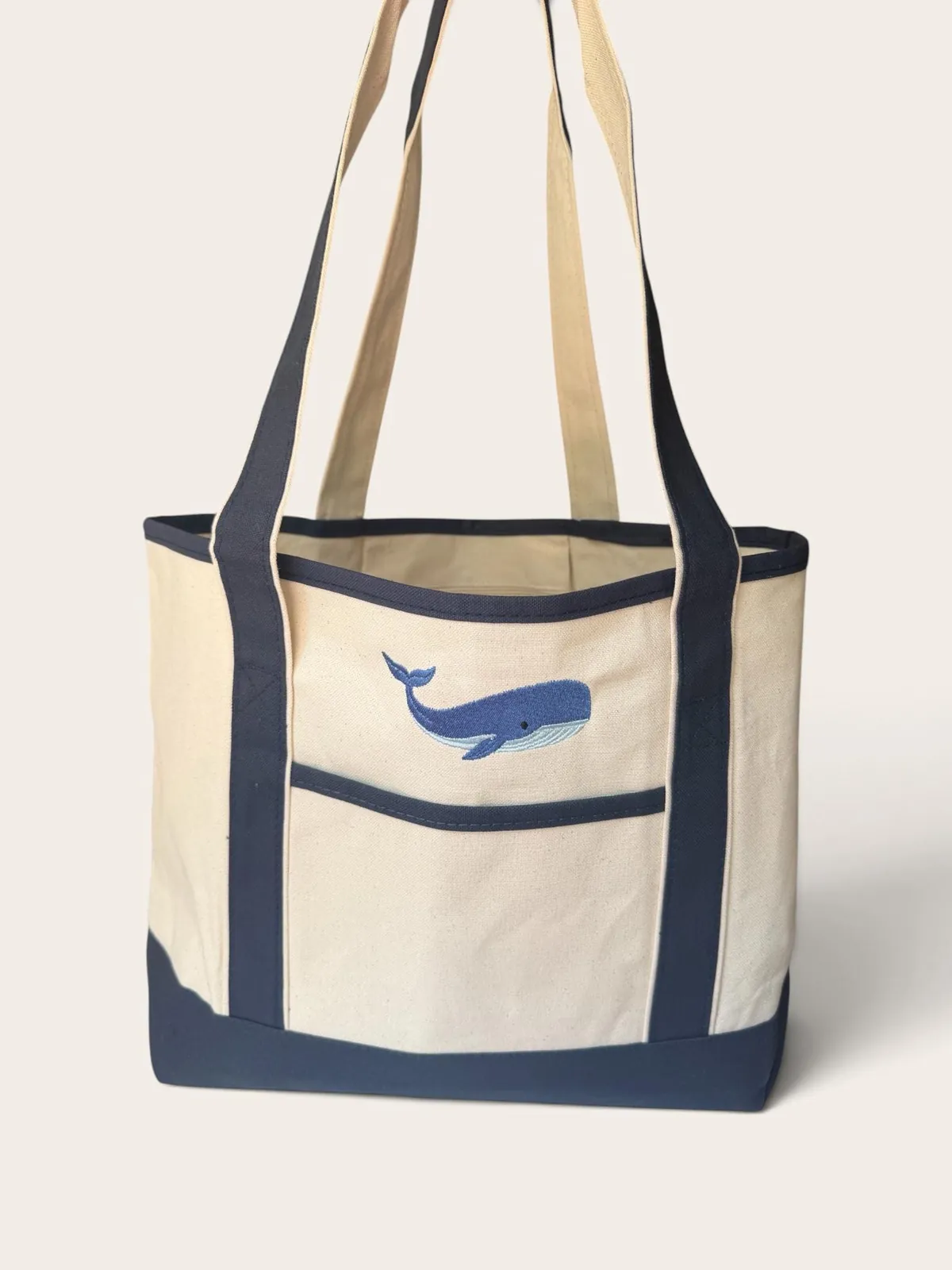 Navy trimmed canvas tote with an embroidered blue whale